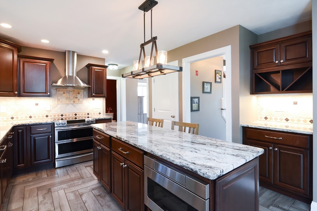 310 Main Street Rutland, MA 01543 - Photo 3 of 39 a kitchen with stainless steel appliances granite countertop wooden cabinets and stove