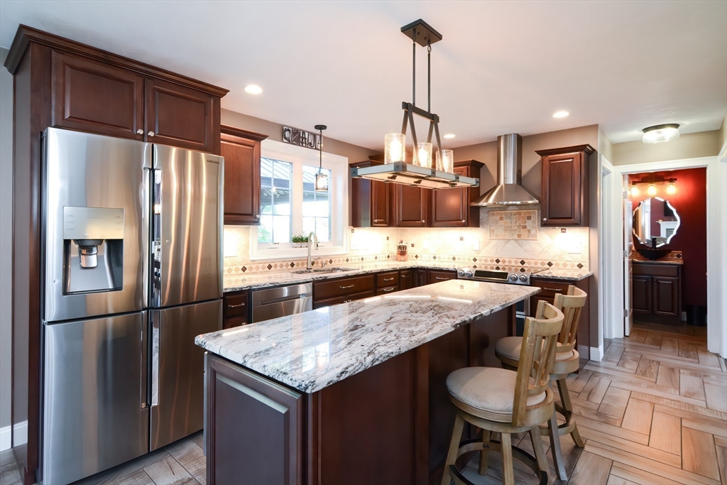 310 Main Street Rutland, MA 01543 - Photo 4 of 39 a kitchen with granite countertop kitchen island stainless steel appliances a sink refrigerator and microwave