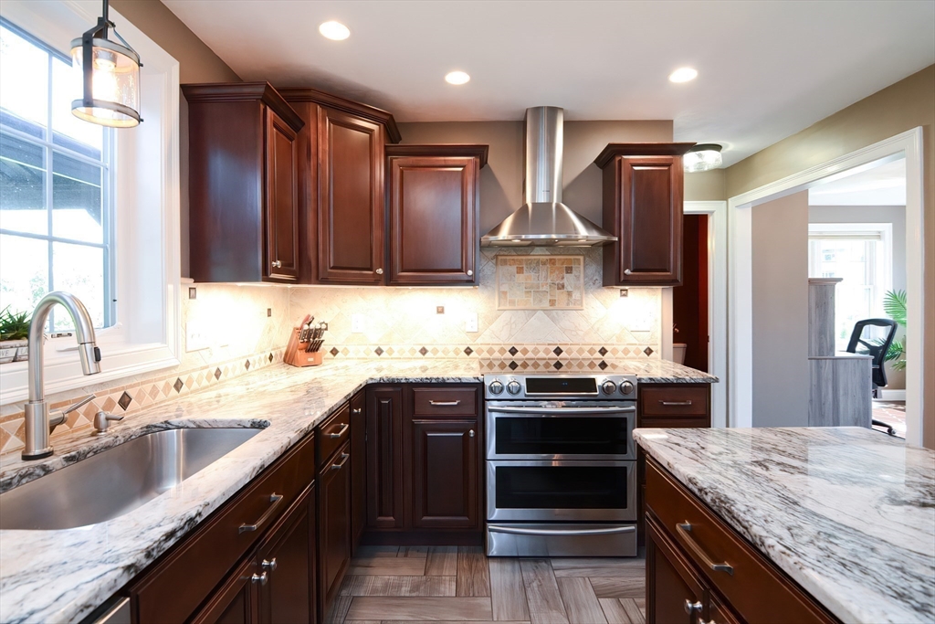 310 Main Street Rutland, MA 01543 - Photo 5 of 39 a kitchen with kitchen island granite countertop a sink stove and refrigerator