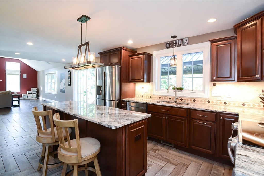 310 Main Street Rutland, MA 01543 - Photo 6 of 39 a kitchen with granite countertop sink stove and dining table
