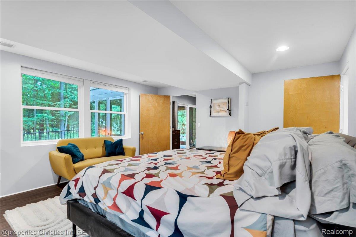 3939 Charing Cross Road Bloomfield Hills, MI 48304 - Photo 33 of 33 Recessed lighting illuminates this room, featuring wood-finish flooring and two windows overlooking exterior foliage