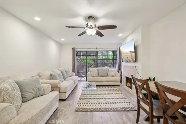 a living room with furniture ceiling fan and a rug