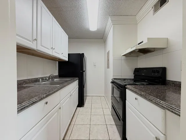a kitchen with stainless steel appliances granite countertop a stove and a sink