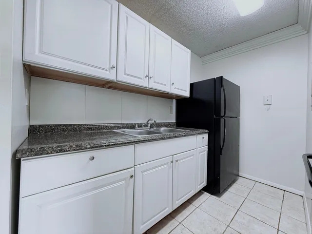 a kitchen with granite countertop cabinets and steel stainless steel appliances