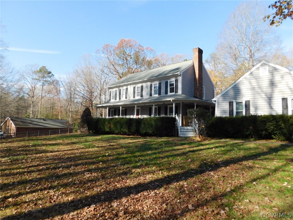 13020 Singer Road Midlothian, VA 23112 - Photo 1 of 33 a view of a big house with a big yard and large trees