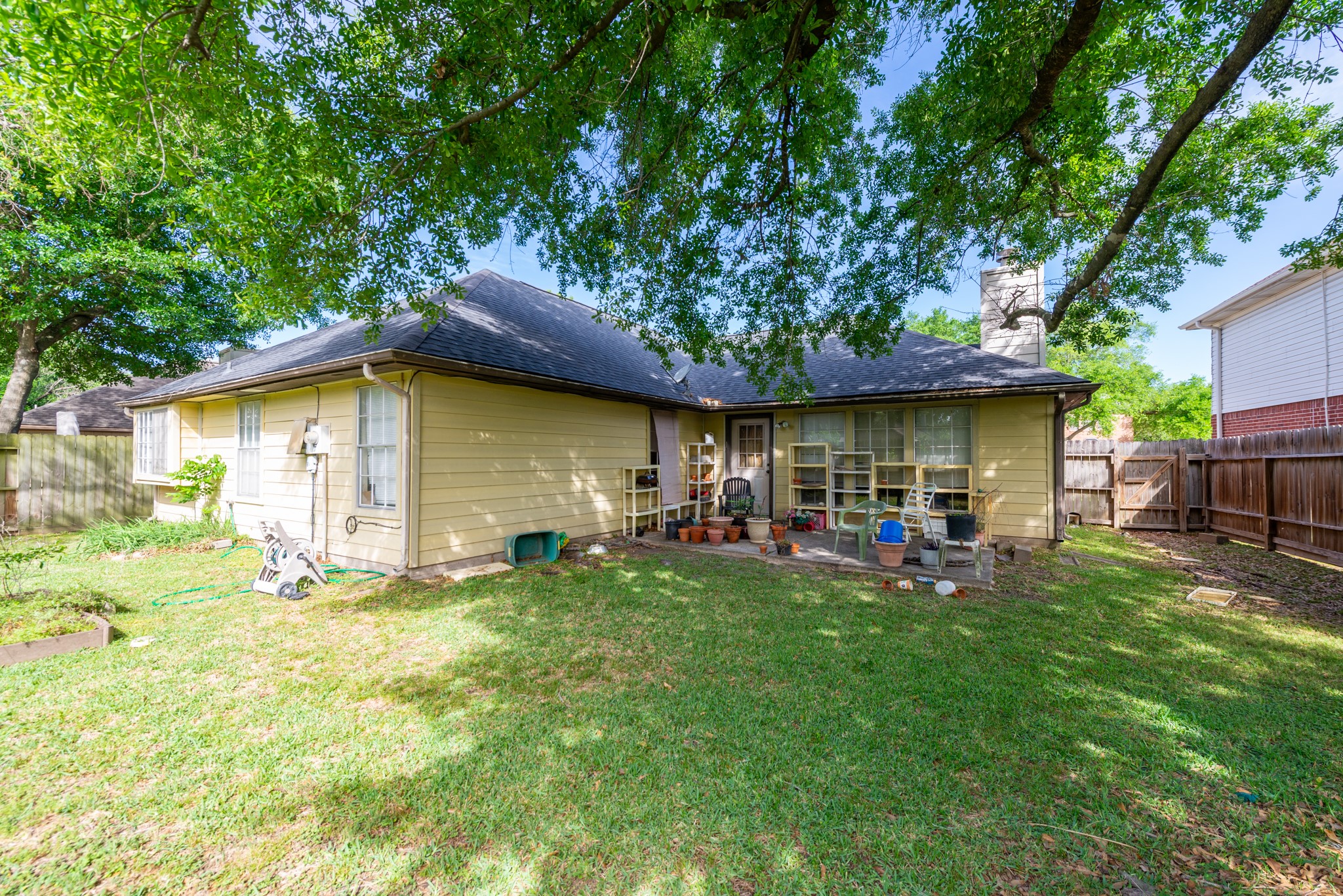 12203 Canterhurst Way Houston, TX 77065 - Photo 22 of 23 a view of a house with backyard porch and sitting area