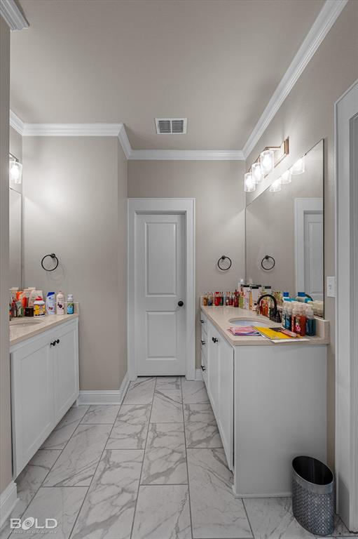 6896 Bethany Reed Circle Blanchard, LA 71107 - Photo 29 of 37 Bathroom featuring dual white vanities with light-toned countertops, large mirrors, and multi-bulb light fixtures
