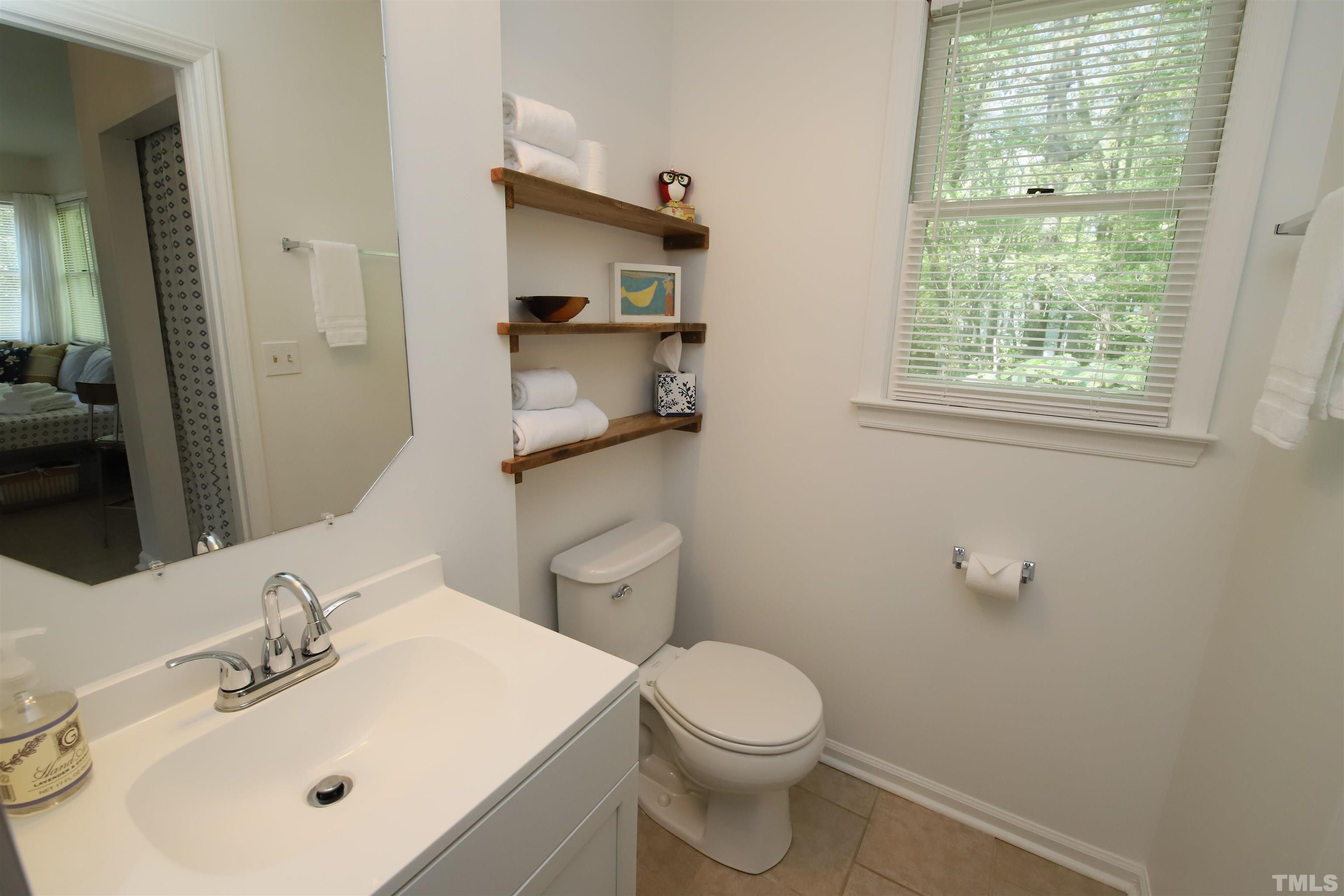 13 Williams Durham, NC 27704 - Photo 13 of 23 a bathroom with a sink a toilet and a mirror