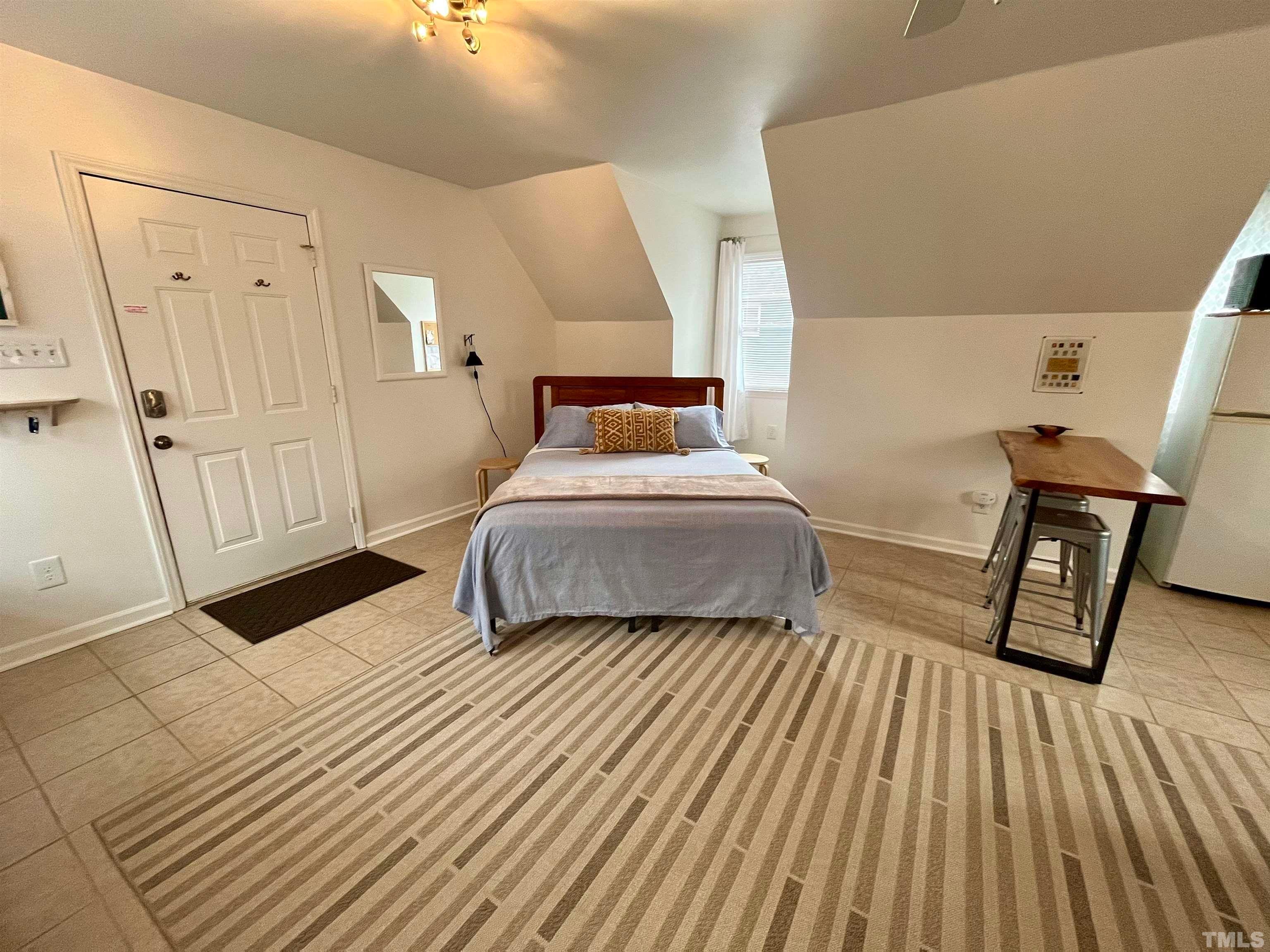 13 Williams Durham, NC 27704 - Photo 5 of 23 a bedroom with a bed and wooden floor