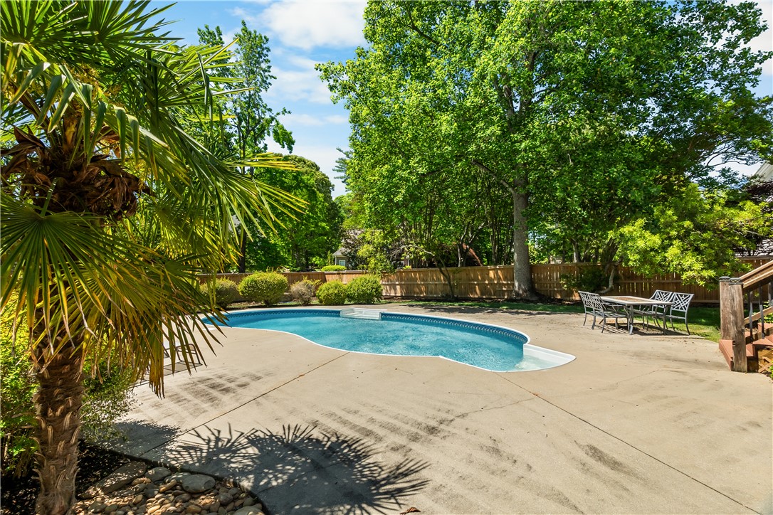 312 English Oak Road Simpsonville, SC 29681 - Photo 42 of 48 This tranquil backyard oasis features a shimmering pool, surrounded by lush greenery and a spacious patio.