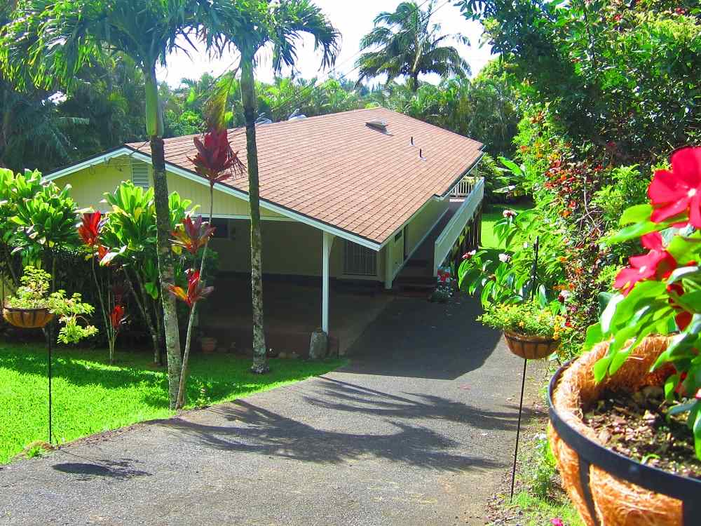 570 West Kuiaha Road, Unit 1 Haiku, HI 96708 - Photo 1 of 27 a house with lots of trees