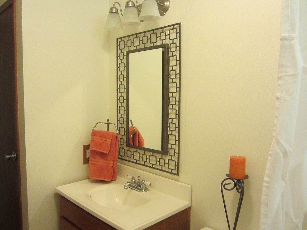 570 West Kuiaha Road, Unit 1 Haiku, HI 96708 - Photo 25 of 27 a bathroom with a sink a toilet and mirror