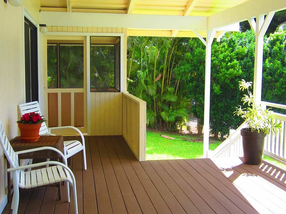 570 West Kuiaha Road, Unit 1 Haiku, HI 96708 - Photo 9 of 27 a view of a deck with a table and chairs and potted plants