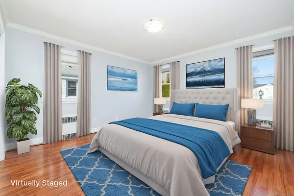 a bedroom with a bed and a painting on the wall