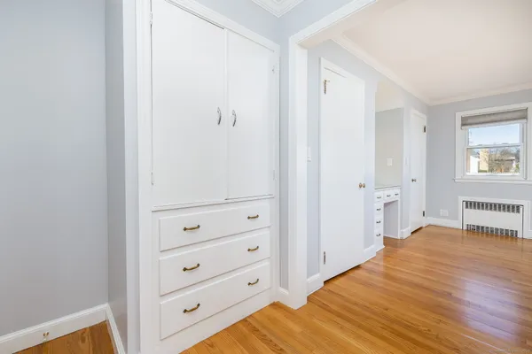 a view of a bedroom with wooden floor