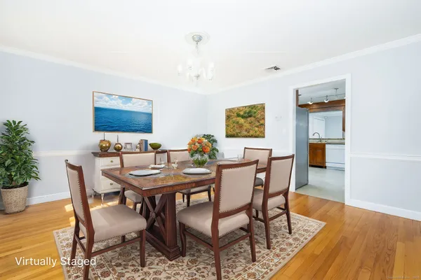 a view of a dining room with furniture and wooden floor