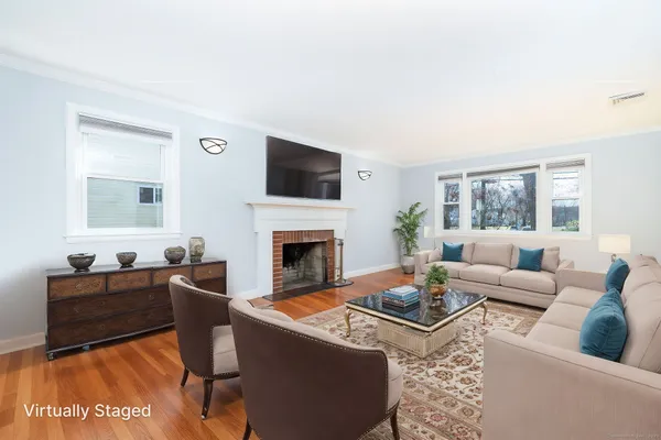 a living room with furniture a fireplace and a flat screen tv