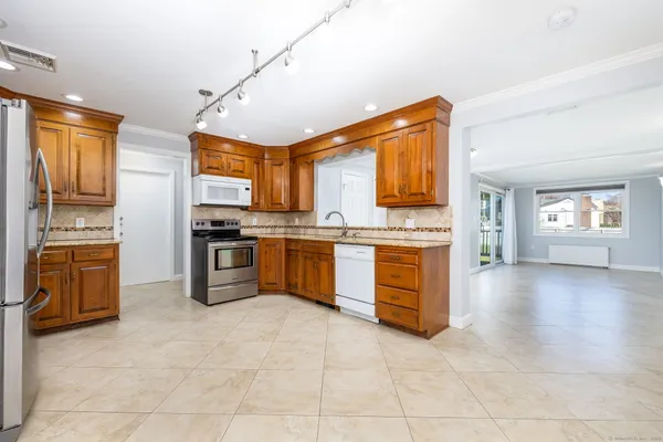 a kitchen with stainless steel appliances granite countertop a stove sink and cabinets