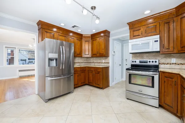 a kitchen with granite countertop a refrigerator and a stove