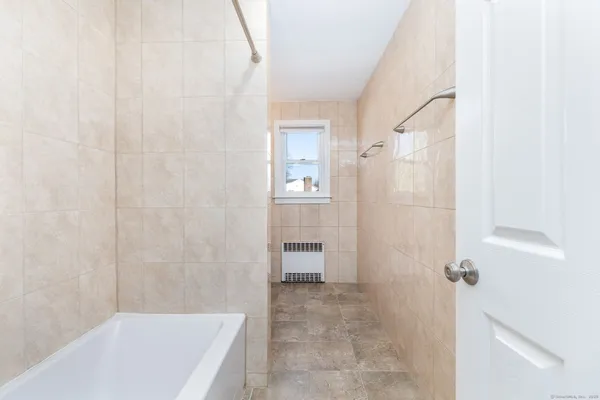 a bathroom with a bathtub and shower