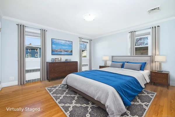a bedroom with a large bed and a painting on the wall