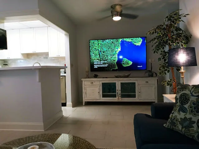 a living room with furniture a flat screen tv and a fireplace