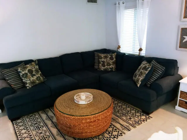 a living room with furniture and a rug