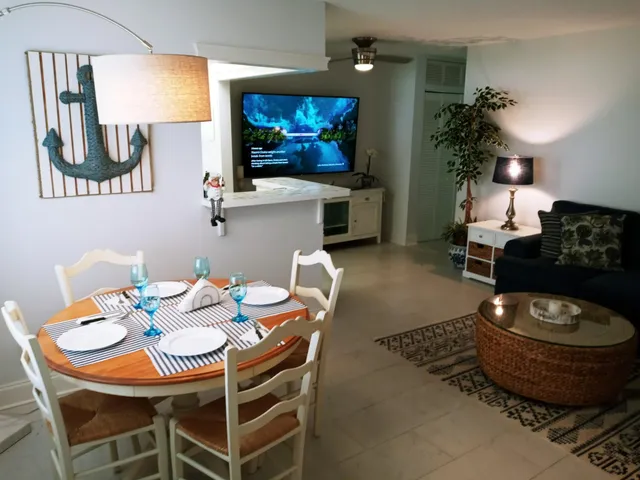 a dining room with furniture and a potted plant