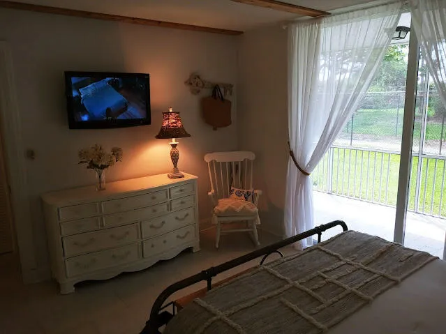 a bed sitting in a bedroom next to a window