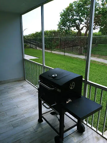 a view of a deck with a table chairs and a yard