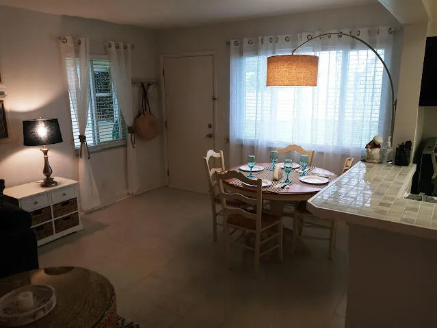 a dining room with furniture and window