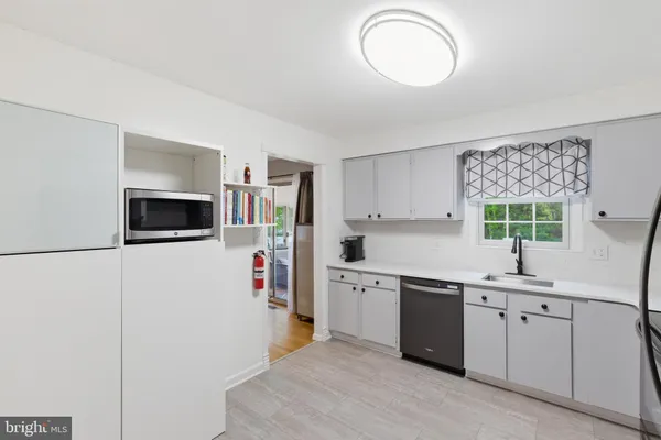 a kitchen with a sink and a refrigerator