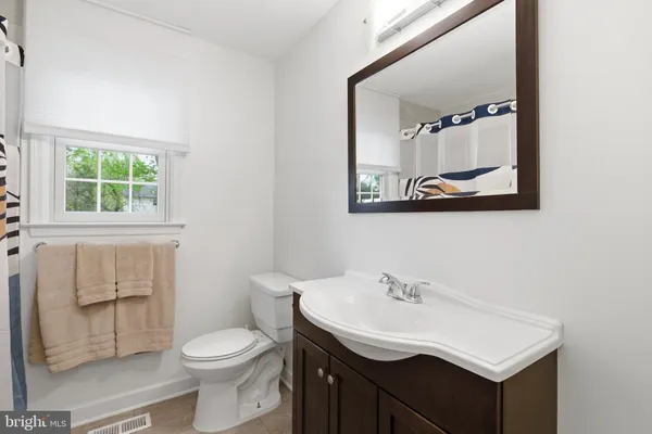 a bathroom with a sink toilet and mirror