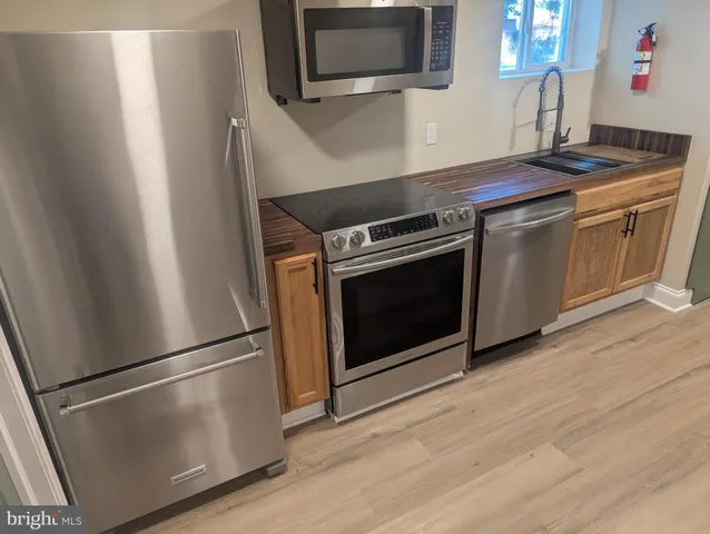 a stove top oven sitting inside of a kitchen