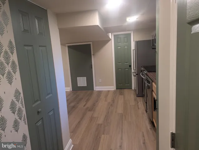 a view of hallway with wooden floor
