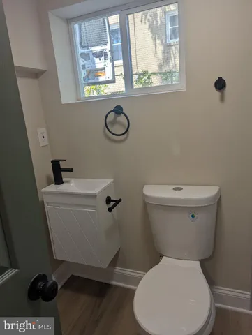 a white toilet sitting next to a bathroom sink