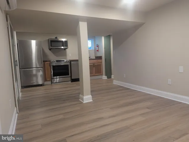 a view of kitchen view wooden floor and electronic appliances