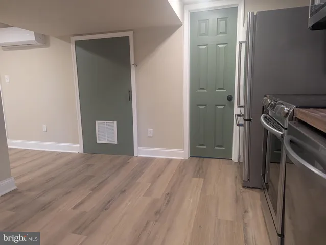 a view of a room with wooden floor