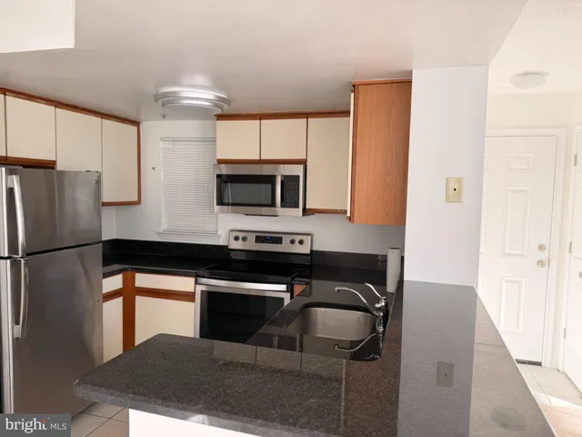a kitchen with a refrigerator and a sink