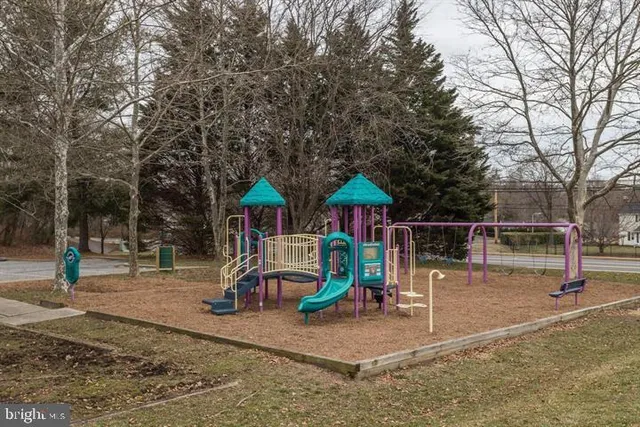 a childrens park with lots of swings and slides