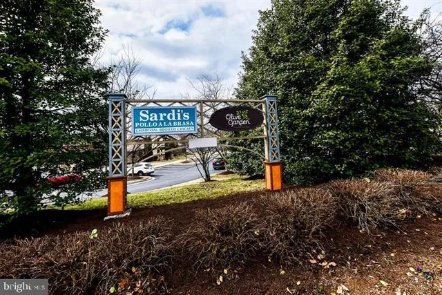 a view of a cars park in front of a building