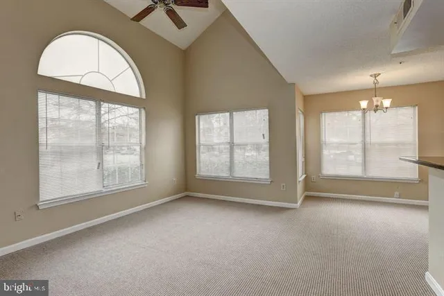 an empty room with windows and outdoor view