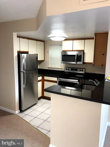 a kitchen with stainless steel appliances a refrigerator and a stove
