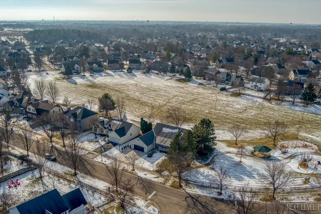 an aerial view of residential houses with yard
