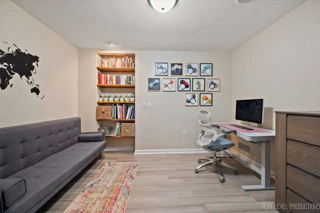 a view of a hallway to a bedroom with wooden floor and bedroom