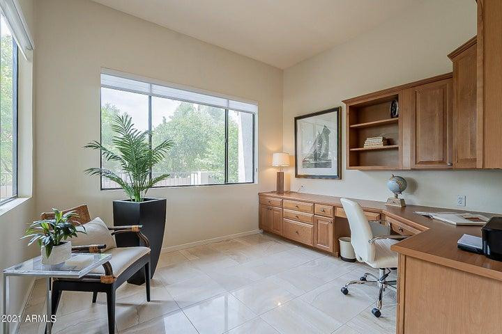 7700 East Gainey Ranch Road, Unit 153 Scottsdale, AZ 85258 - Photo 14 of 24 a kitchen with granite countertop a stove a sink and a refrigerator