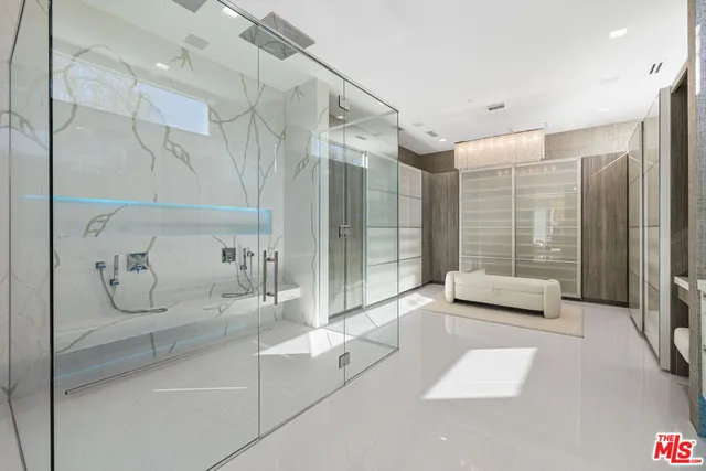 a bedroom with a large bed and painting on the wall