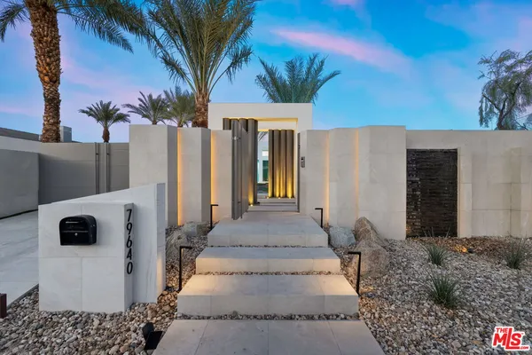 a view of a patio with couches table and chairs and potted plants