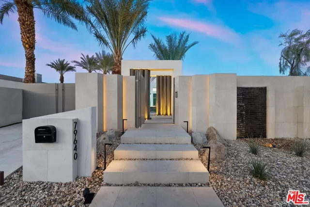 a view of a patio with couches table and chairs and potted plants