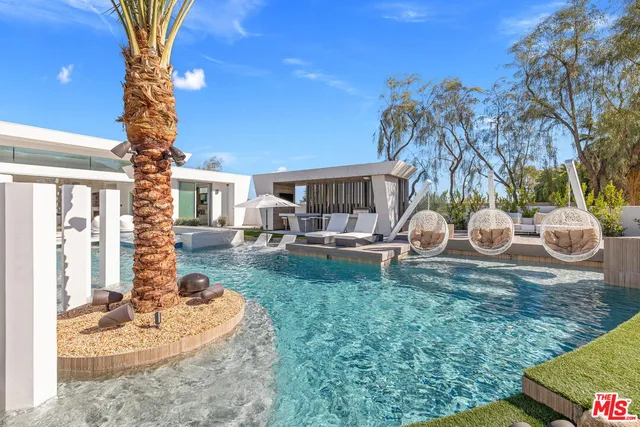 a view of a house with backyard porch and sitting area
